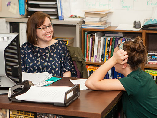 Mrs. Lydon talking with a student